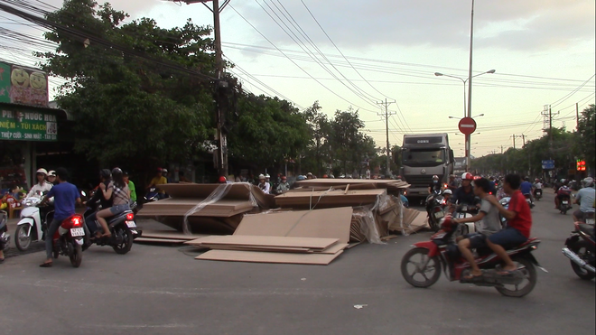 Hàng trăm tấm gỗ ép trên xe container lao xuống đường, nhiều người thoát chết - Ảnh 3.