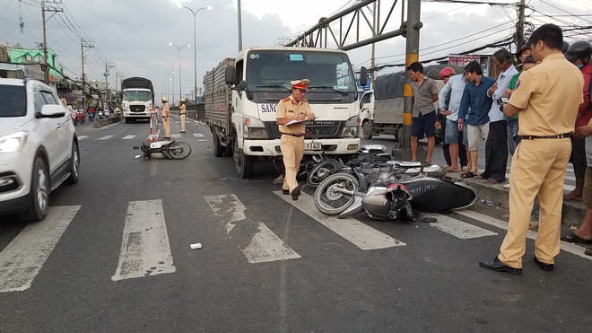 Ôtô tải tông hàng loạt xe máy giữa giao lộ Sài Gòn, SH cuốn vào gầm, nhiều người bị thương - Ảnh 1.