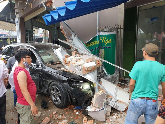 Mercedes và Lexus tông nhau nát đầu giữa ngã tư, tông sập tường tiệm thuốc tây trong khu dân cư - Ảnh 1.