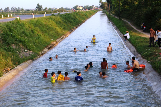 Nắng nóng, dân Nghệ An mang can nhựa, thùng xốp đổ xô ra sông Lam, kênh nước tắm - Ảnh 11.