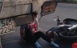 Người phụ nữ ngồi thất thần sau khi ngã gần bánh sau xe tải