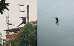 Người đàn ông say rượu trèo lên cột cao thế, đu dây điện như biểu diễn xiếc