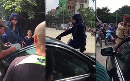 Một phụ nữ đeo kính đen, trèo lên nóc ô tô đánh ghen giữa phố HN