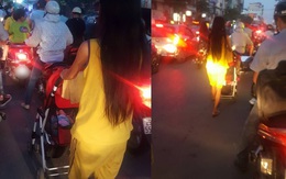 Người phụ nữ đẩy xe nôi em bé giữa phố tắc đường đầy khói xe