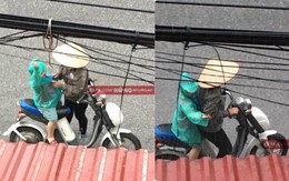 Hình ảnh người mẹ đội nón lá dừng xe giữa đường mặc áo mưa cho con trai gây xúc động