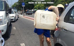 Giữa trưa nắng gắt, người phụ nữ tranh thủ dừng xe, tự đổ xăng gây ách tắc