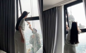 Mát lòng cảnh cô gái mời nước anh thợ treo mình giữa trời nóng lau kính cao ốc