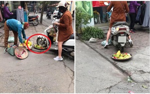 Bức xúc người phụ nữ cán nát mẹt hoa quả của cô bán hàng rong vì ngồi chắn cửa
