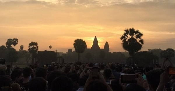 Tourists flock to see the moment of sunrise on top of Angkor Wat temple