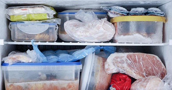 How often should the freezer compartment be cleaned to avoid food contamination?
