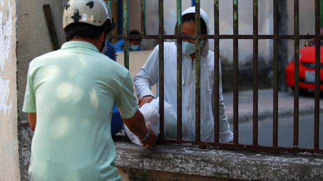 [ẢNH] Phong toả chung cư có ca nhiễm Covid-19 thứ 48 ở Sài Gòn, cư dân nhận tiếp tế lương thực qua hàng rào