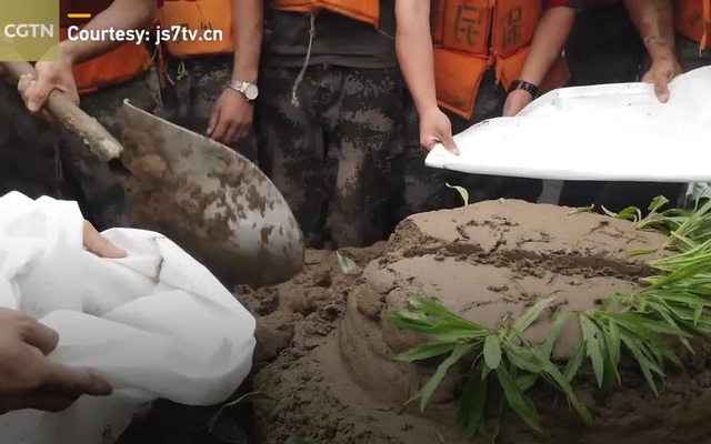 Binh sĩ Trung Quốc nhận bánh sinh nhật bằng bùn giữa lúc vật lộn chống lũ
