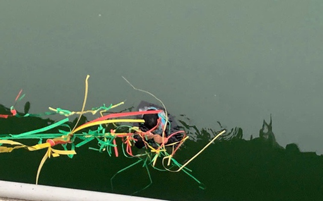 Hình ảnh người đàn ông đu mình dưới sông chờ ứng cứu sau khi nhảy cầu tự tử