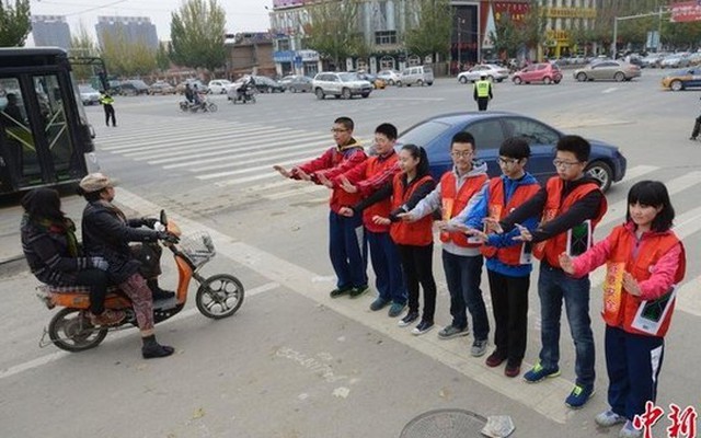 Học sinh xây "tường người" giữa đường để ngăn người dân vượt đèn đỏ